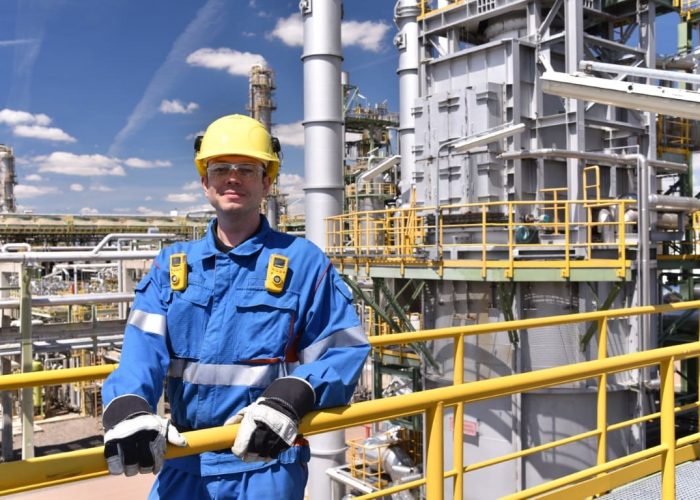 workers in an industrial plant for the production and processing of crude oil